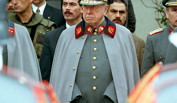 SANTIAGO, CHILE:  Former Chilean leader and current Commander of the Chilean Armed Forces, Gen. Augusto Pinochet listens to a military band playing before his residence in Santiago 11 September to commemorate the 24th anniversary of the coup he led to overthrow the government of Salvador Allende. Pinochet is expected to retire in 1998.    AFP PHOTO/CRIS BOURONCLE (Photo credit should read CRIS BOURONCLE/AFP/Getty Images)